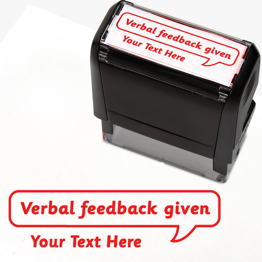 Rectangular self-inking stamper measuring 59mm by 21mm, featuring the phrase 'Your Text Here' leading onto a speech bubble going above it also saying 'Verbal Feedback Given'. In red ink.