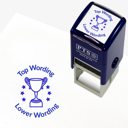A 25mm round pre-inked teacher stamper with blue ink, featuring a trophy with three stars either side, curving above the image is space for personalisation 'Top Wording' and curving below the image is space for personalisation 'Lower Wording' in a clear, bold font.
