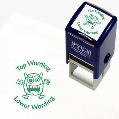 A 25mm round pre-inked teacher stamper with green ink, featuring a monster with it's arms open wide and it's mouth open, curving above the image is space for personalisation 'Top Wording' and curving below the image is space for personalisation 'Lower Wording' in a clear, bold font.