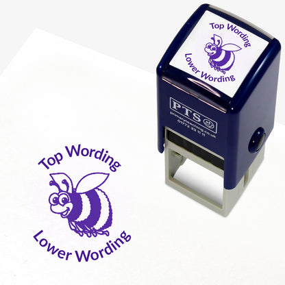 A 25mm round pre-inked teacher stamper with purple ink, featuring a smiling bee, curving above the image is space for personalisation 'Top Wording' and curving below the image is space for personalisation 'Lower Wording' in a clear, bold font.