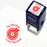 A 25mm round pre-inked teacher stamper with red ink, featuring a central design of a target with an arrow hitting the bullseye, curving above the target is space for personalisation 'Top Wording' and curving below the target is space for personalisation 'Lower Wording' in a clear, bold font.