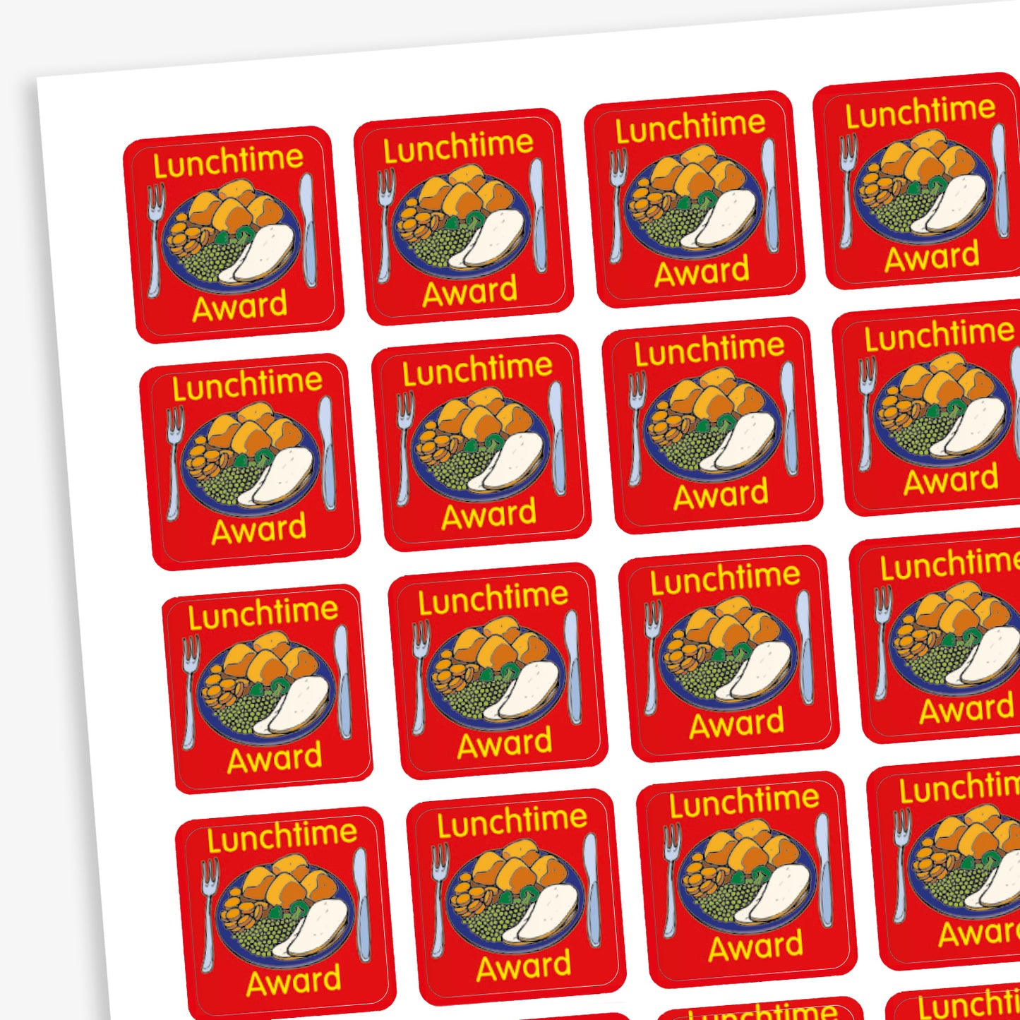 A sheet of square reward stickers with a red background, each featuring a colourful illustration of a dinner plate with vegetables, potatoes, and a drink. The text 'Lunchtime Award' is written in yellow above and below the image. Each sticker also includes a knife and fork graphic on either side of the plate. 