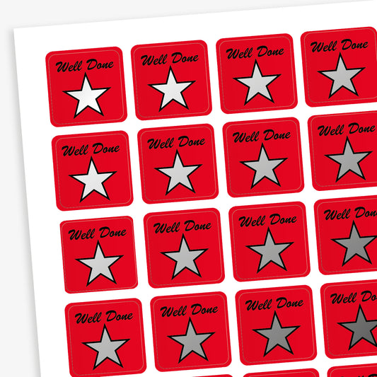 A sheet of 140 square 16mm reward stickers, each featuring the phrase 'Well Done' in black script text above a large silver star set against a vibrant red background.