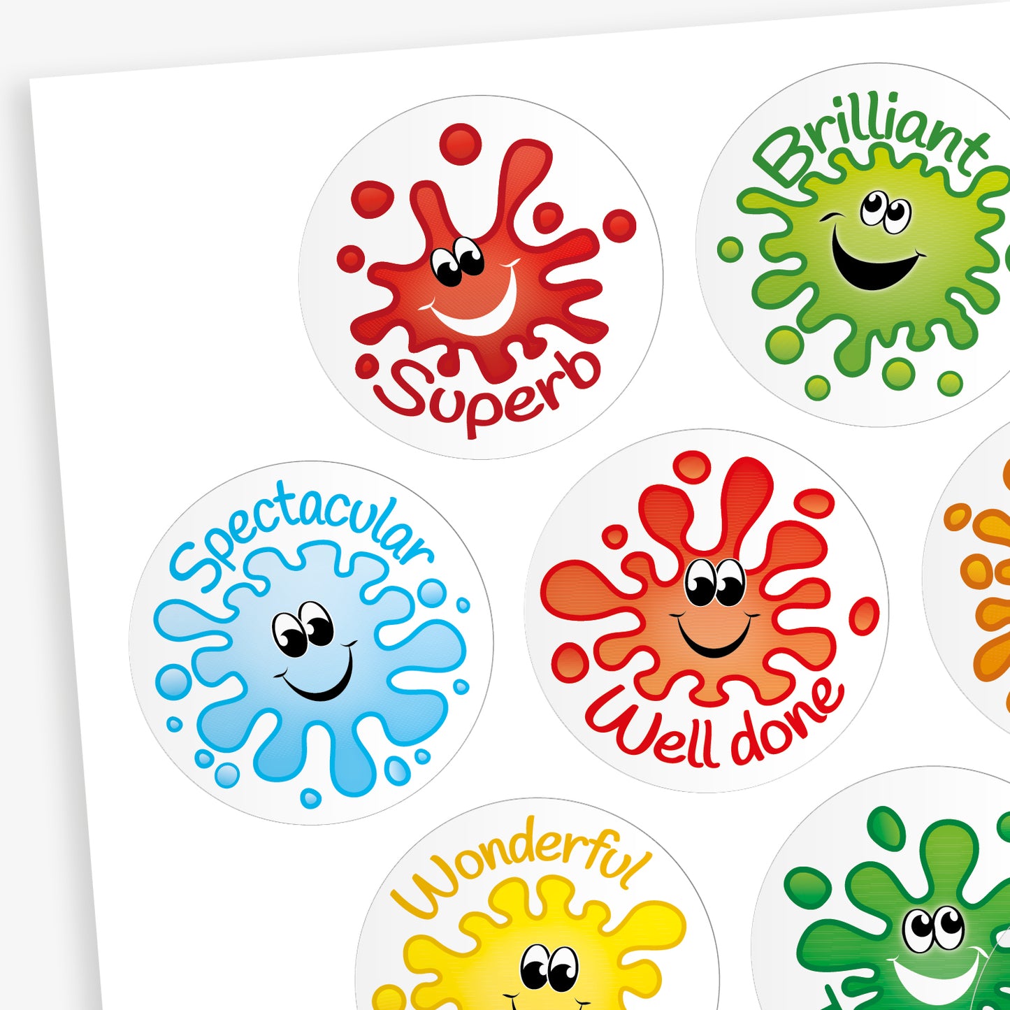 A sheet of round, jellybean scented reward stickers, each featuring a colourful paint splat character with a smiling face. The stickers include positive words in playful fonts, such as 'Superb' on a red splat, 'Brilliant' on a green splat, 'Tremendous' on a darker green splat, and 'Magnificent' on a purple splat. Each design is vibrant and visually engaging.