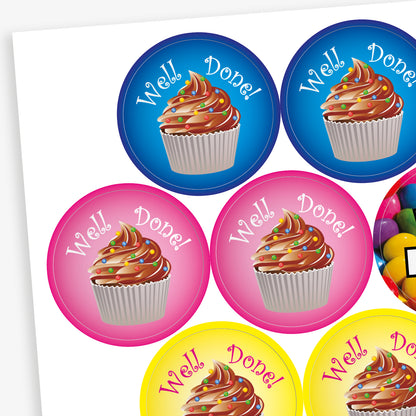 Sheet of 32mm chocolate-scented reward stickers featuring assorted colourful designs, including smiling chocolate characters, cupcakes, doughnuts, and sweets, each displaying motivational phrases like 'Well Done' and 'Amazing Work'; designed for rewarding pupils' achievements.