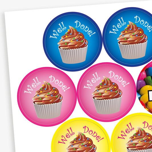 Sheet of 32mm chocolate-scented reward stickers featuring assorted colourful designs, including smiling chocolate characters, cupcakes, doughnuts, and sweets, each displaying motivational phrases like 'Well Done' and 'Amazing Work'; designed for rewarding pupils' achievements.