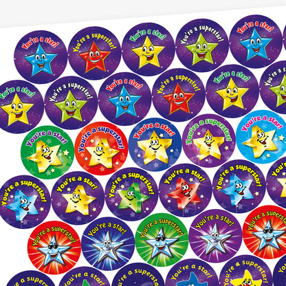 A sheet of 32mm stickers each with a cartoon, bright coloured, smiling star against a galaxy background.  Phrases inclue 'You're a star!' and 'You're a superstar'.