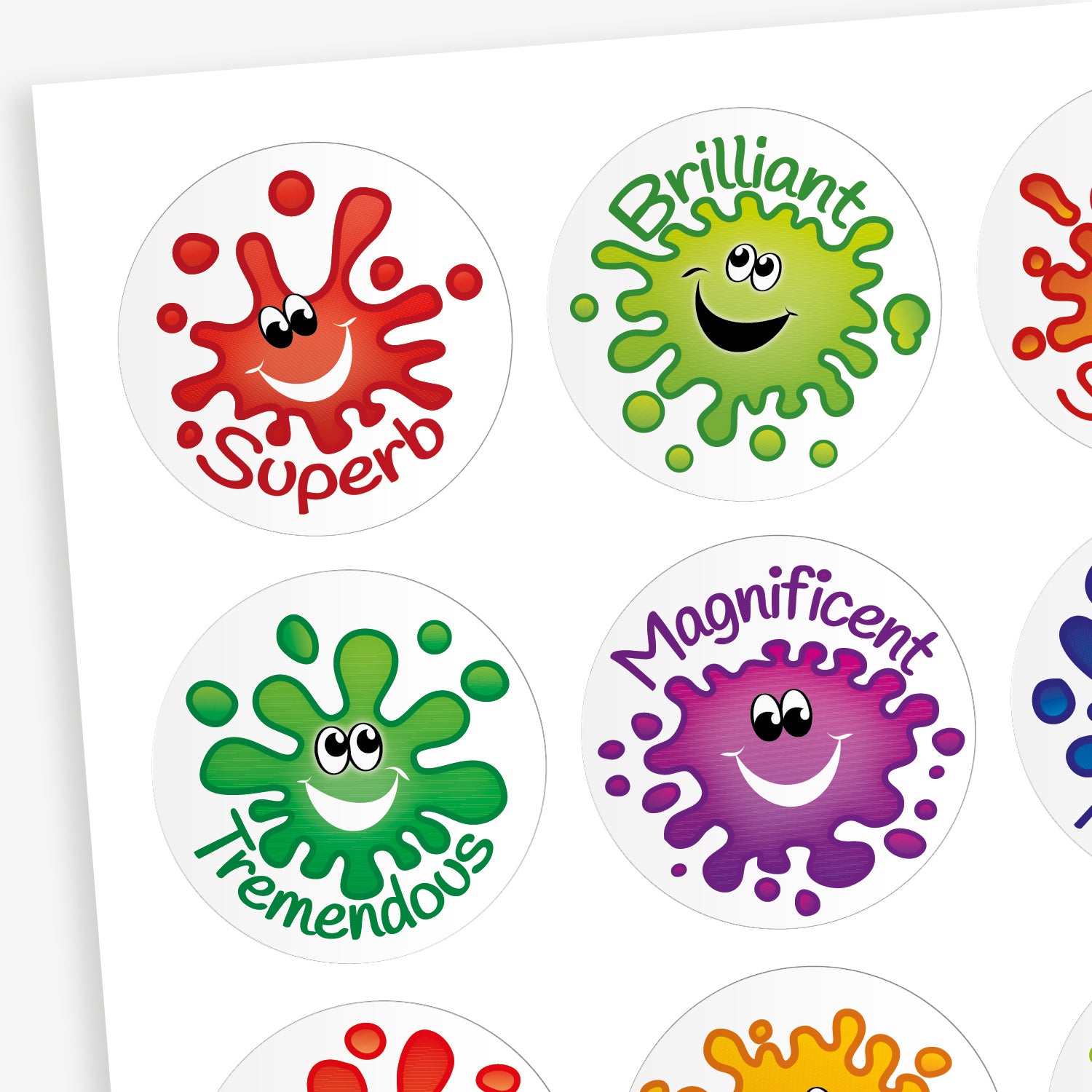 A sheet of round, jellybean scented reward stickers, each featuring a colourful paint splat character with a smiling face. The stickers include positive words in playful fonts, such as 'Superb' on a red splat, 'Brilliant' on a green splat, 'Tremendous' on a darker green splat, and 'Magnificent' on a purple splat. Each design is vibrant and visually engaging.